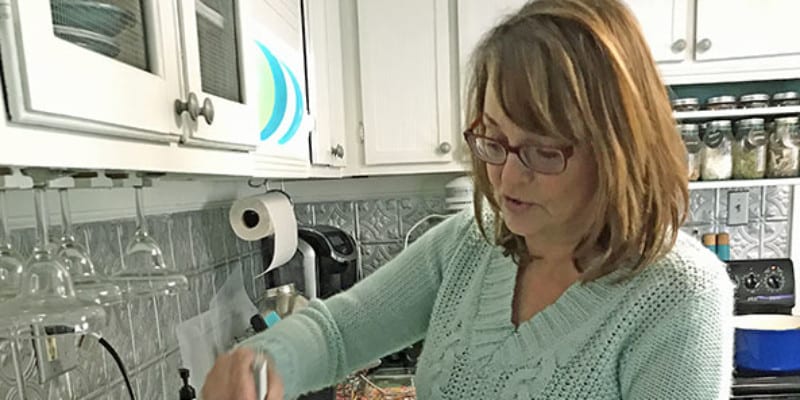 person making homemade mozzarella in instant pot in kitchen at home