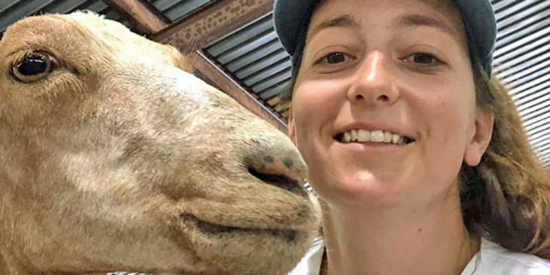 Selfie of woman and tan goat