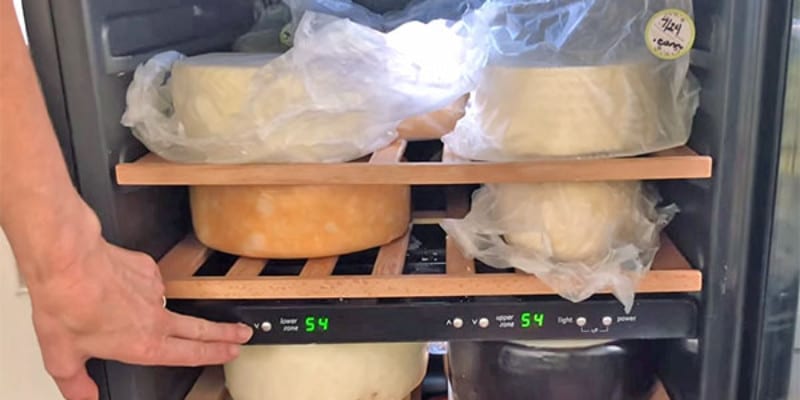 cheese wheels inside a fridge