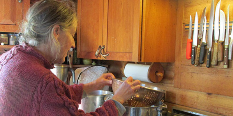 woman checkin strainer and pot