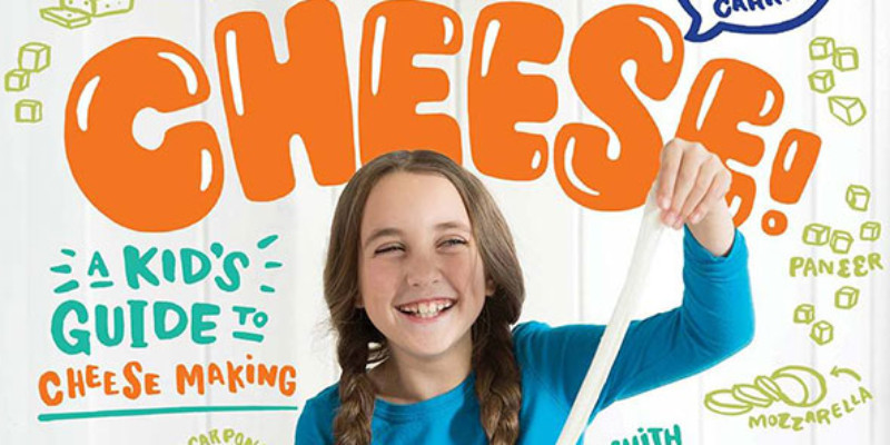 a girl smiling on a Say Cheese book and kit cover